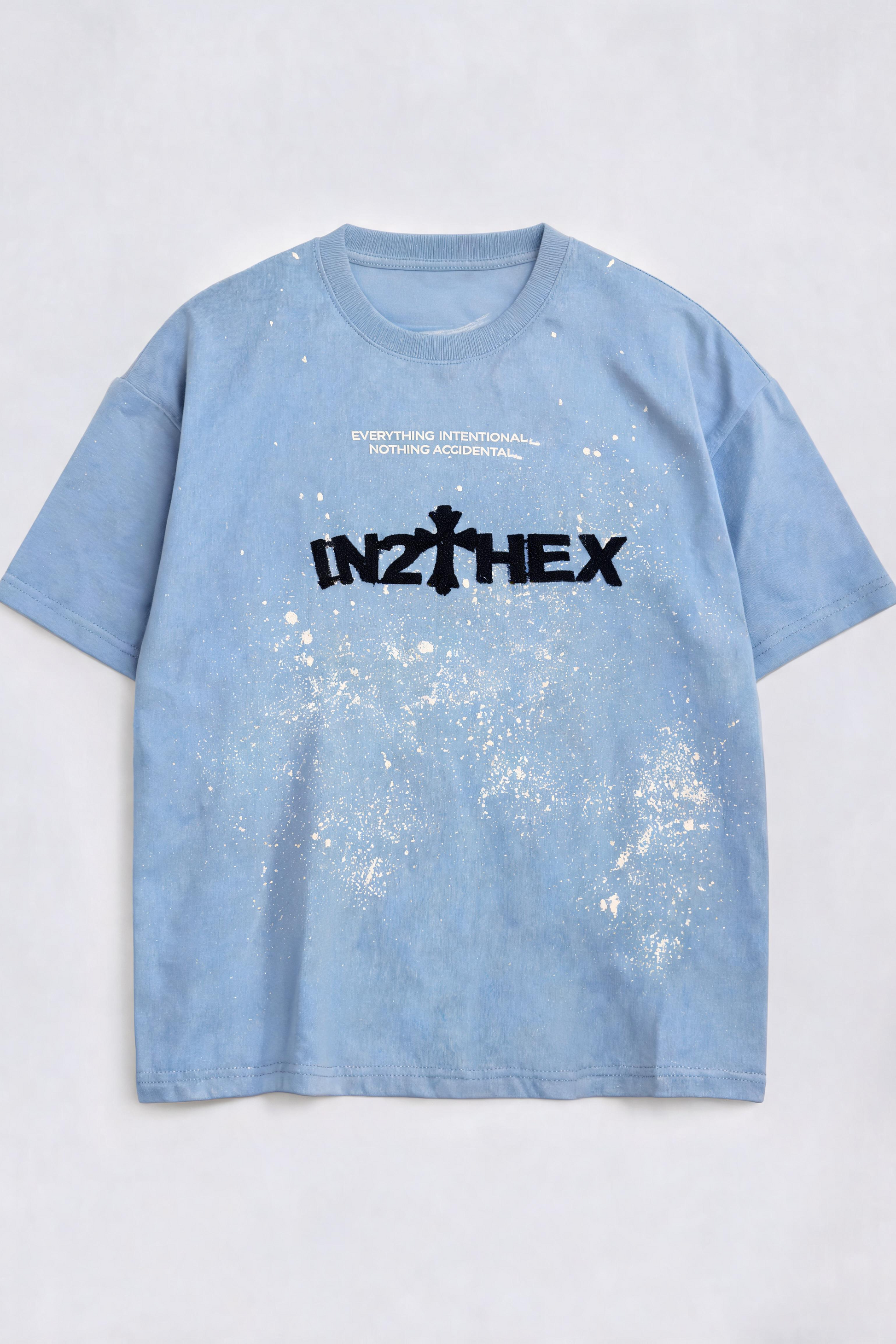Blue t-shirt with a black logo and text on a light gray background