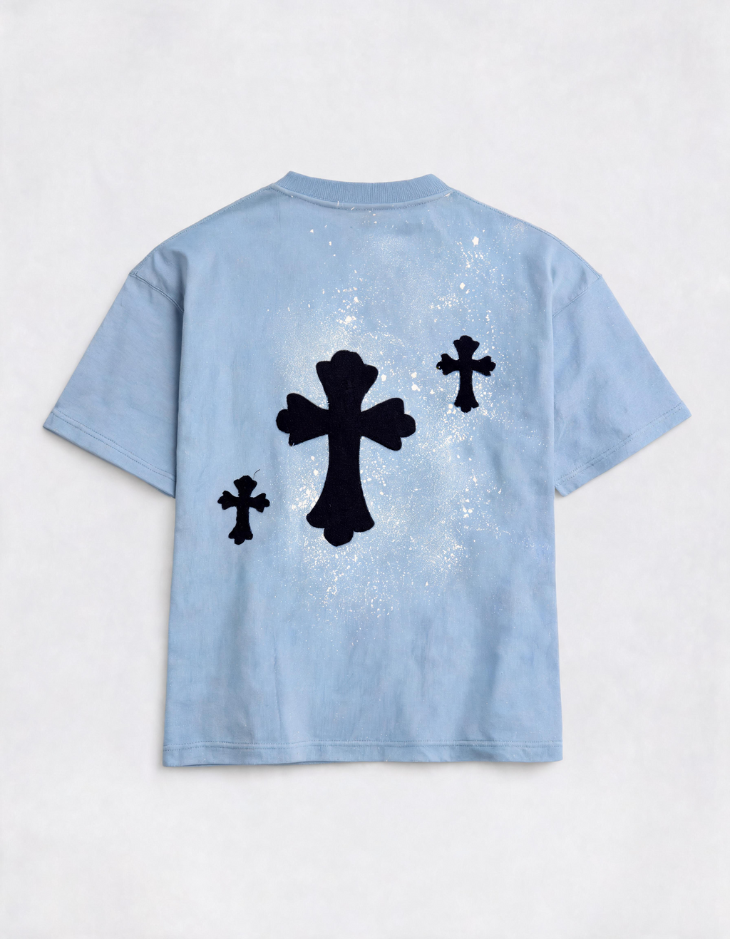 Light blue t-shirt with black cross designs on a white background
