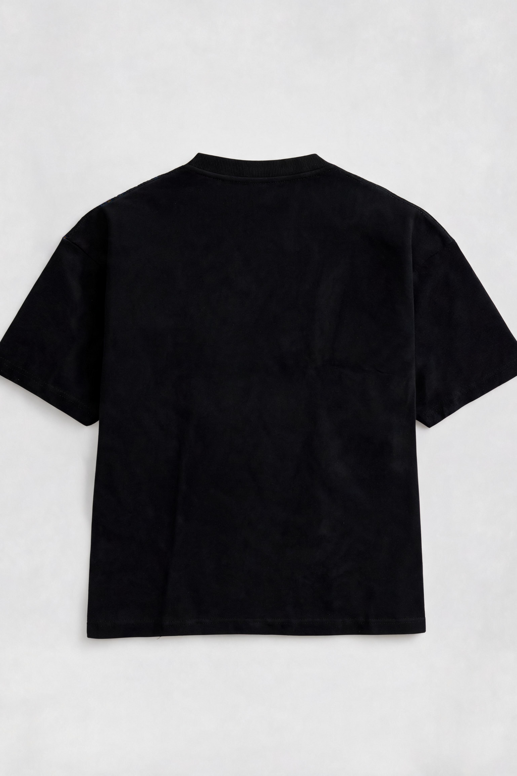 Black t-shirt on a light gray background