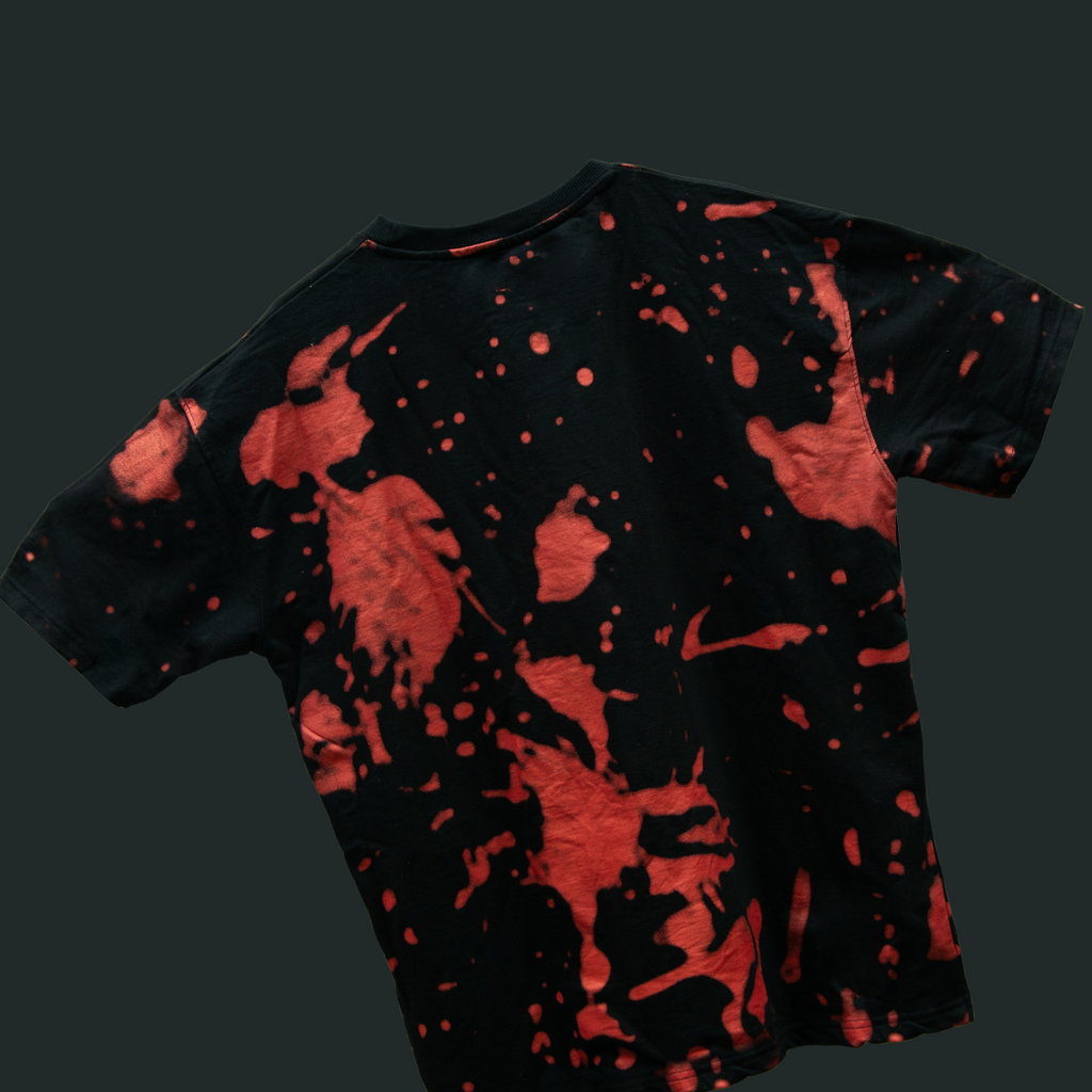 Black t-shirt with red abstract pattern on a dark background