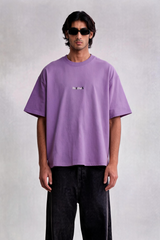 Person wearing a purple t-shirt and black pants on a white background