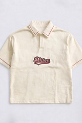 Beige polo shirt with red trim and embroidered logo on a light gray background