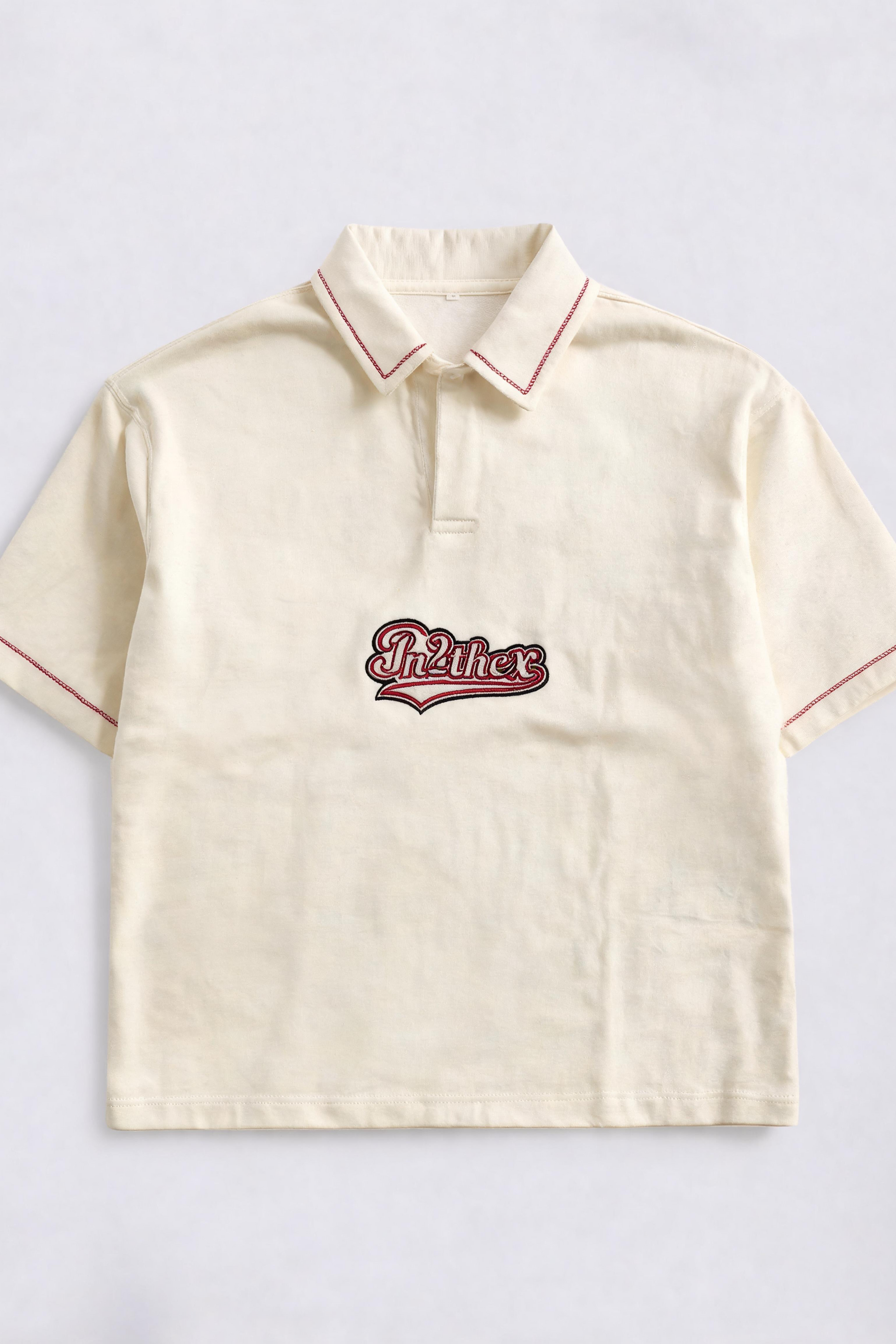 Beige polo shirt with red trim and embroidered logo on a light gray background