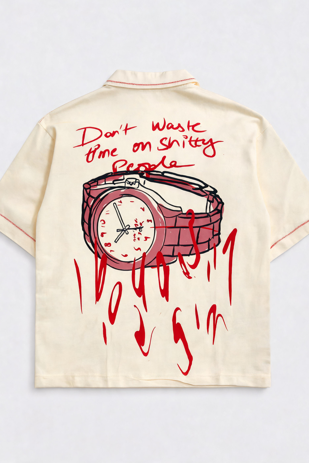 Beige shirt with red graphic of a watch and text on a light gray background