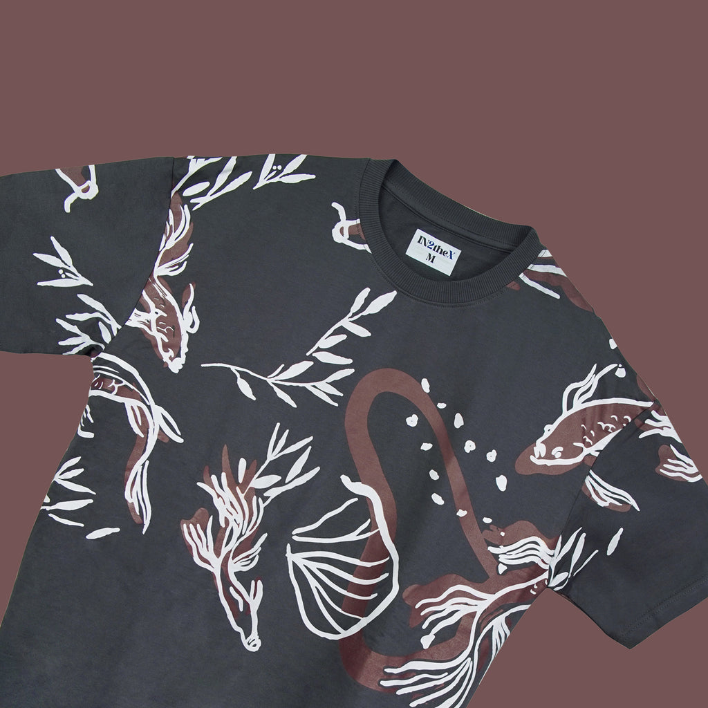 Black t-shirt with white and brown floral pattern on a dark background