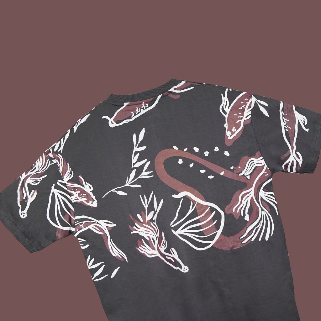 Black t-shirt with white and red floral patterns on a brown background